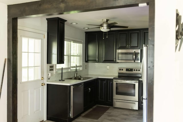 212 Woodland Rd, Bassett, VA 24055 - kitchen with stainless steel appliances, a sink, a ceiling fan, light countertops, and dark cabinetry