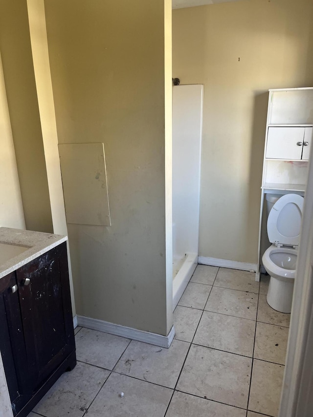 2816 10th St NW, Roanoke, VA 24012 - full bath with toilet, vanity, tile patterned flooring, baseboards, and a shower