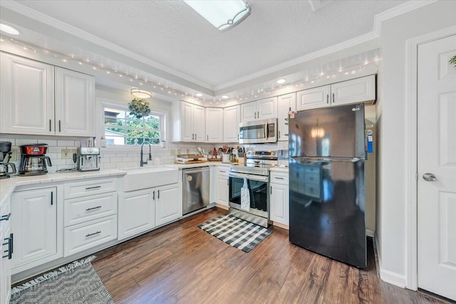 1028 Park Mountain Ter, Huddleston, VA 24104 - kitchen featuring stainless steel appliances, a sink, crown molding, white cabinets, and a textured ceiling