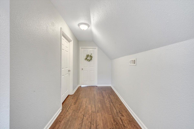 1028 Park Mountain Ter, Huddleston, VA 24104 - corridor with dark wood-style flooring, a textured ceiling, a textured wall, vaulted ceiling, and baseboards