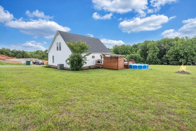 1028 Park Mountain Ter, Huddleston, VA 24104 - rear view of house with an outdoor pool, a lawn, and central AC unit