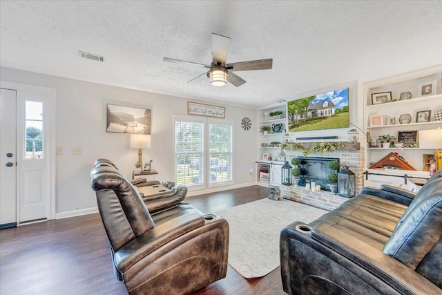 1028 Park Mountain Ter, Huddleston, VA 24104 - living area featuring wood finished floors, a textured ceiling, a ceiling fan, baseboards, and a fireplace