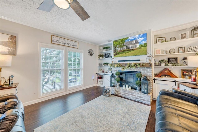 1028 Park Mountain Ter, Huddleston, VA 24104 - living area featuring a ceiling fan, wood finished floors, a fireplace, baseboards, and a textured ceiling