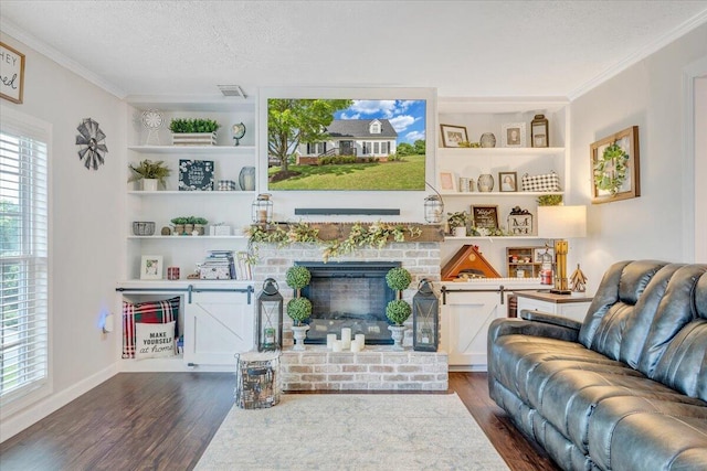 1028 Park Mountain Ter, Huddleston, VA 24104 - living area with dark wood-style floors, built in shelves, ornamental molding, a textured ceiling, and a brick fireplace