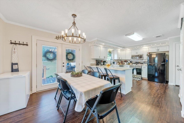 1028 Park Mountain Ter, Huddleston, VA 24104 - dining area with dark wood-style flooring, a chandelier, a textured ceiling, and ornamental molding
