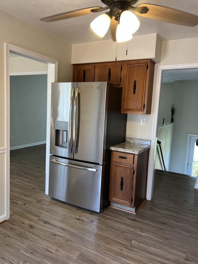 1878 Cranwell Dr, Vinton, VA 24179 - kitchen with stainless steel fridge with ice dispenser, a ceiling fan, dark wood-style flooring, brown cabinetry, and light stone countertops