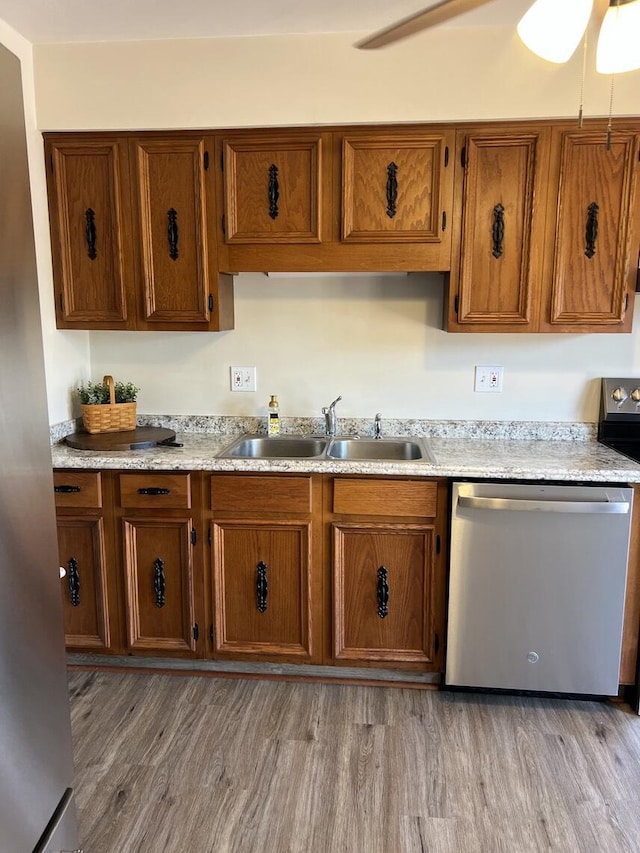 1878 Cranwell Dr, Vinton, VA 24179 - kitchen featuring a sink, appliances with stainless steel finishes, brown cabinetry, light countertops, and light wood-style flooring