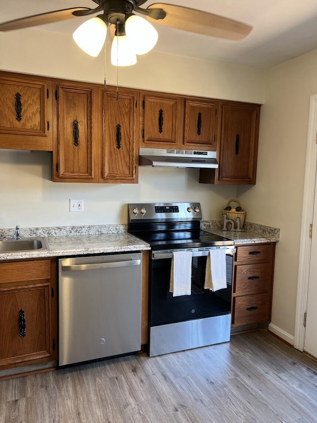 1878 Cranwell Dr, Vinton, VA 24179 - kitchen with appliances with stainless steel finishes, under cabinet range hood, a sink, ceiling fan, and brown cabinets