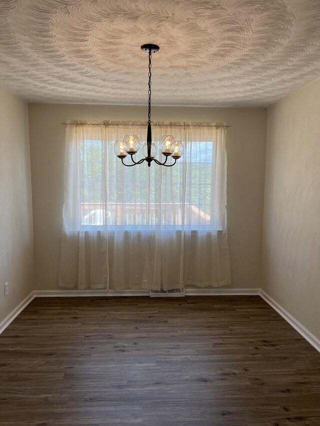 1878 Cranwell Dr, Vinton, VA 24179 - unfurnished dining area featuring a chandelier, dark wood-style floors, a textured ceiling, and baseboards