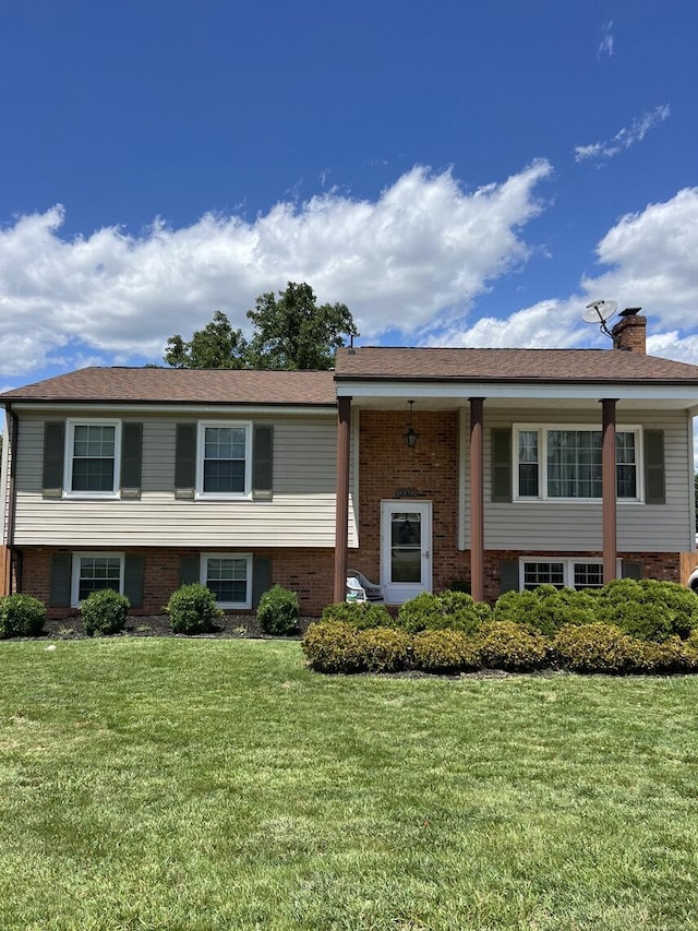 1878 Cranwell Dr, Vinton, VA 24179 - split foyer home featuring brick siding, a front yard, and a chimney
