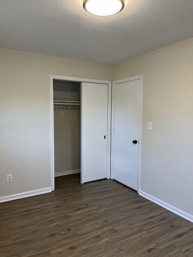 1878 Cranwell Dr, Vinton, VA 24179 - unfurnished bedroom with dark wood-style flooring, a closet, and baseboards