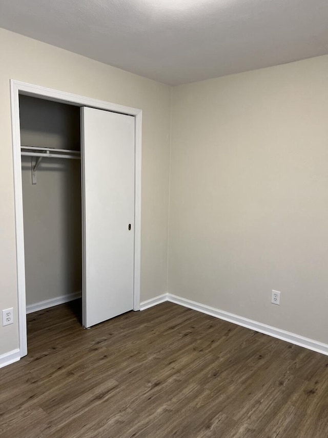 1878 Cranwell Dr, Vinton, VA 24179 - unfurnished bedroom featuring dark wood finished floors, baseboards, and a closet