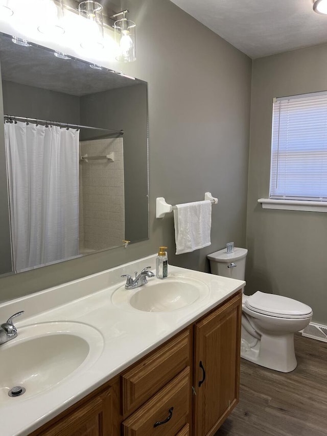 1878 Cranwell Dr, Vinton, VA 24179 - full bathroom with toilet, double vanity, wood finished floors, and a shower with curtain
