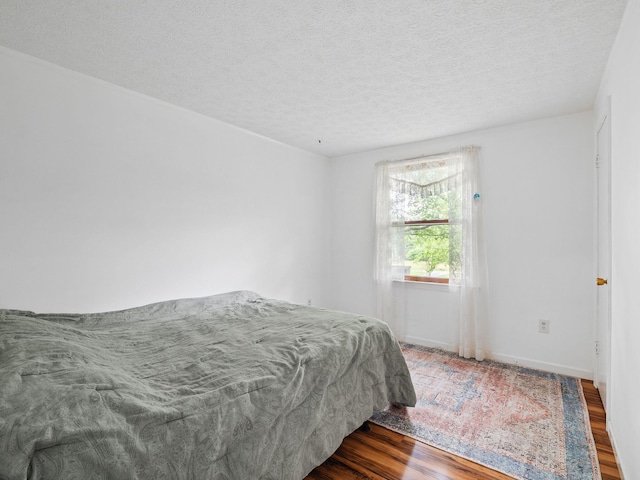 6357 Breckinridge Mill Rd, Fincastle, VA 24090 - bedroom featuring wood finished floors, a textured ceiling, and baseboards