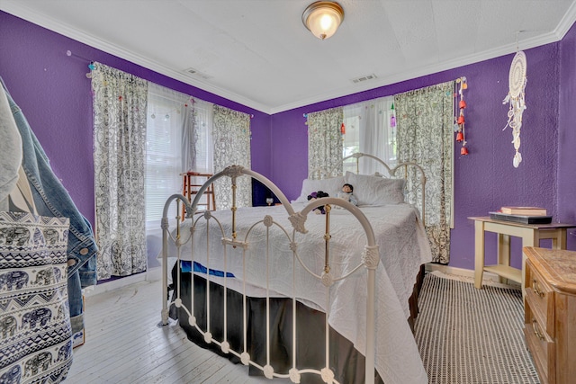 1514 Redwood Rd SE, Roanoke, VA 24014 - bedroom with multiple windows, crown molding, a textured wall, baseboards, and wood-type flooring