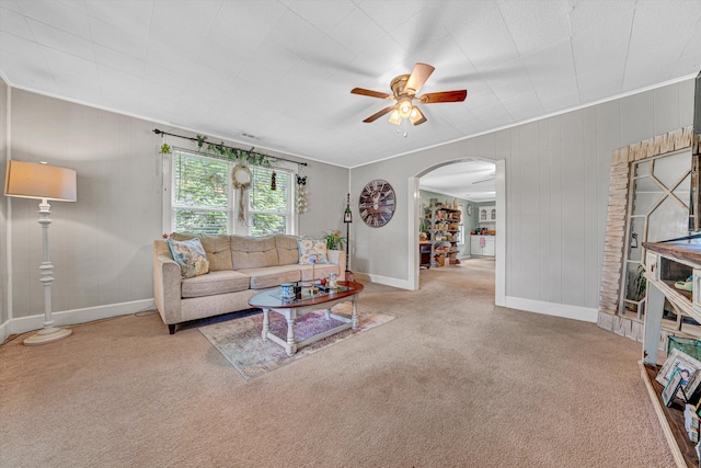 1514 Redwood Rd SE, Roanoke, VA 24014 - carpeted living area featuring arched walkways, ceiling fan, ornamental molding, baseboards, and wood walls