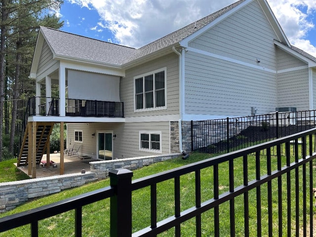 844 Lakewatch Cir, Moneta, VA 24121 - back of property with stairway, a patio, roof with shingles, and a sunroom