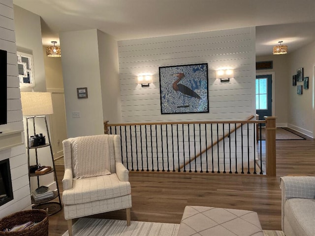 844 Lakewatch Cir, Moneta, VA 24121 - living area featuring wood finished floors, an upstairs landing, a chandelier, and a fireplace