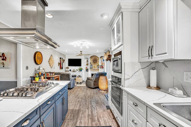 2440 Charing Cross Dr, Roanoke, VA 24018 - kitchen with blue cabinets, island range hood, appliances with stainless steel finishes, white cabinetry, and recessed lighting
