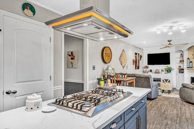2440 Charing Cross Dr, Roanoke, VA 24018 - kitchen featuring blue cabinetry, ventilation hood, stainless steel gas cooktop, open floor plan, and wood finished floors
