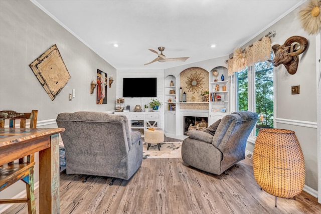 2440 Charing Cross Dr, Roanoke, VA 24018 - living area featuring ornamental molding, wood finished floors, a fireplace with flush hearth, built in shelves, and ceiling fan