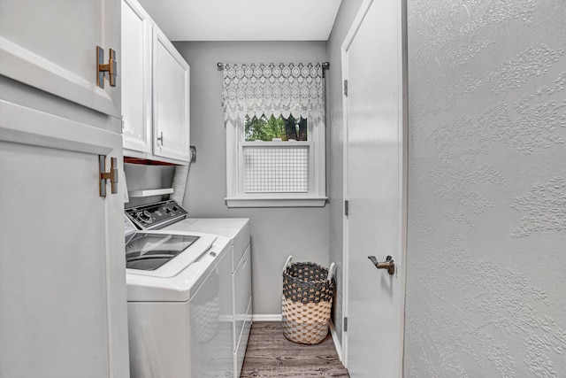 2440 Charing Cross Dr, Roanoke, VA 24018 - laundry area featuring cabinet space, washing machine and clothes dryer, wood finished floors, and baseboards