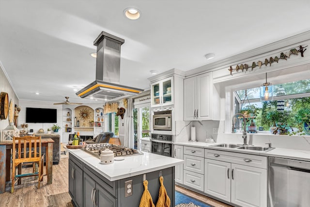 2440 Charing Cross Dr, Roanoke, VA 24018 - kitchen featuring appliances with stainless steel finishes, a sink, island range hood, white cabinets, and plenty of natural light