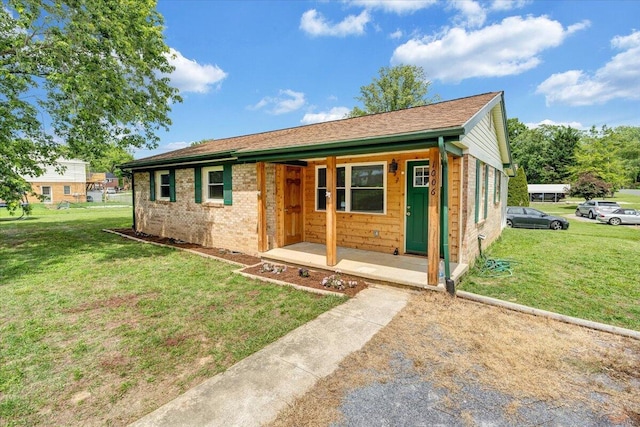 1006 10th St, Glasgow, VA 24555 - ranch-style home with a porch, a front lawn, and brick siding