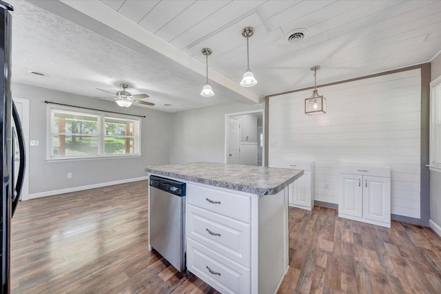 1006 10th St, Glasgow, VA 24555 - kitchen with dishwasher, dark wood-type flooring, white cabinetry, light countertops, and black fridge