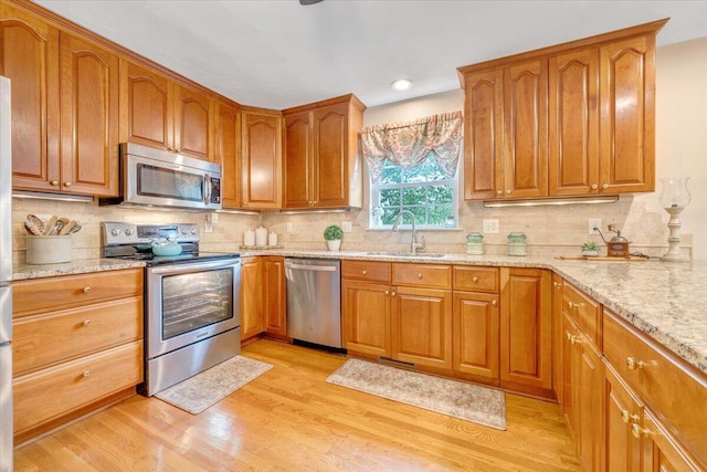 610 Crystal Anne Ln, Roanoke, VA 24019 - kitchen featuring appliances with stainless steel finishes, a sink, light wood-style flooring, light stone counters, and recessed lighting
