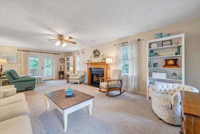 610 Crystal Anne Ln, Roanoke, VA 24019 - living room with light carpet, a ceiling fan, a fireplace with flush hearth, and baseboards
