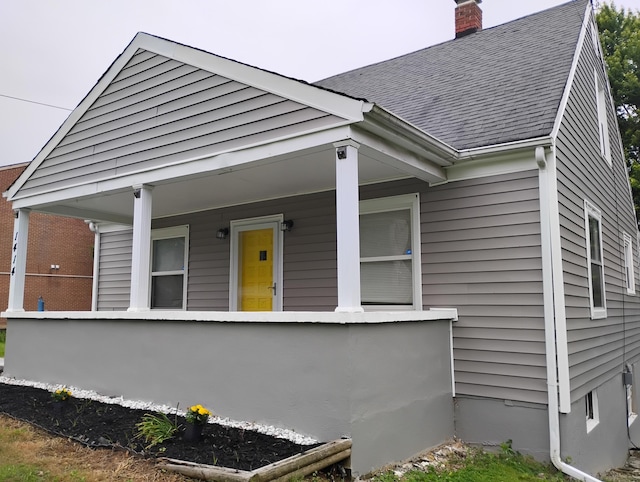 1414 Westside Blvd NW, Roanoke, VA 24017 - view of front facade with a shingled roof, a chimney, and a porch