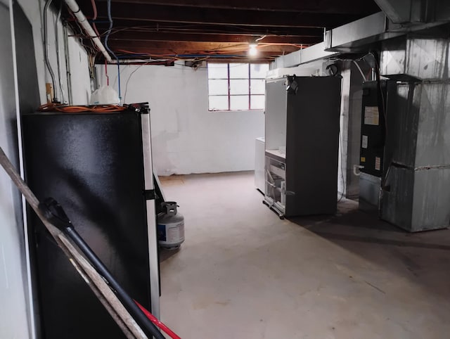 1414 Westside Blvd NW, Roanoke, VA 24017 - basement featuring freestanding refrigerator and heating unit