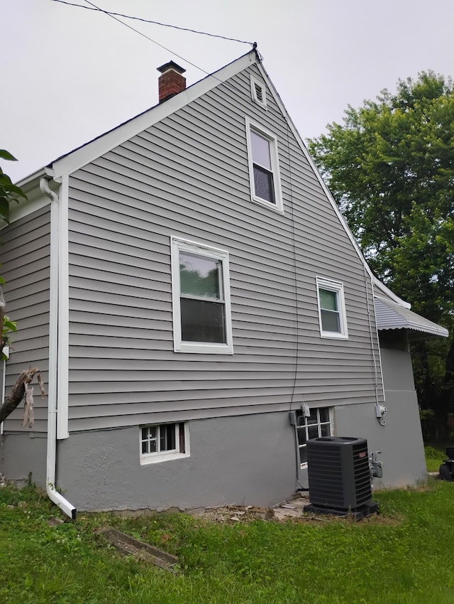 1414 Westside Blvd NW, Roanoke, VA 24017 - view of home's exterior with central air condition unit and a chimney