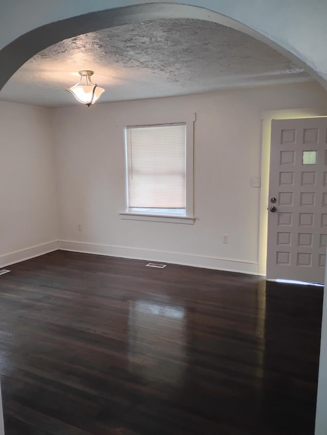 1414 Westside Blvd NW, Roanoke, VA 24017 - entrance foyer with baseboards, arched walkways, dark wood-style floors, and a textured ceiling