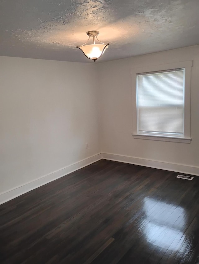 1414 Westside Blvd NW, Roanoke, VA 24017 - spare room featuring dark wood-style flooring, baseboards, and a textured ceiling