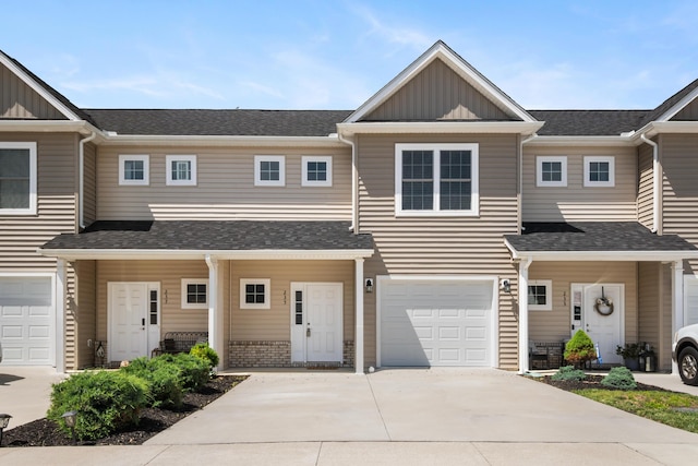 235 Louise Ln, Elliston, VA 24087 - view of property with board and batten siding, concrete driveway, a garage, a shingled roof, and a porch