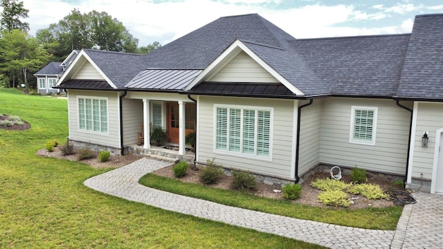 1115 Oakshire Ln, Wirtz, VA 24184 - ranch-style home featuring a standing seam roof, a front yard, roof with shingles, and a metal roof