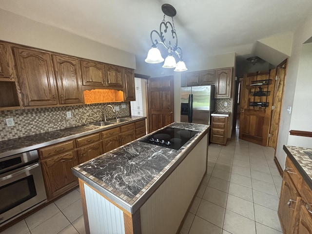 120 Nyle Ridge Rd, Wirtz, VA 24184 - kitchen featuring appliances with stainless steel finishes, backsplash, a kitchen island, light tile patterned floors, and dark countertops