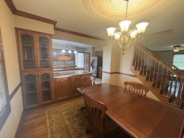 120 Nyle Ridge Rd, Wirtz, VA 24184 - dining space featuring dark wood-type flooring, a chandelier, stairway, a ceiling fan, and crown molding
