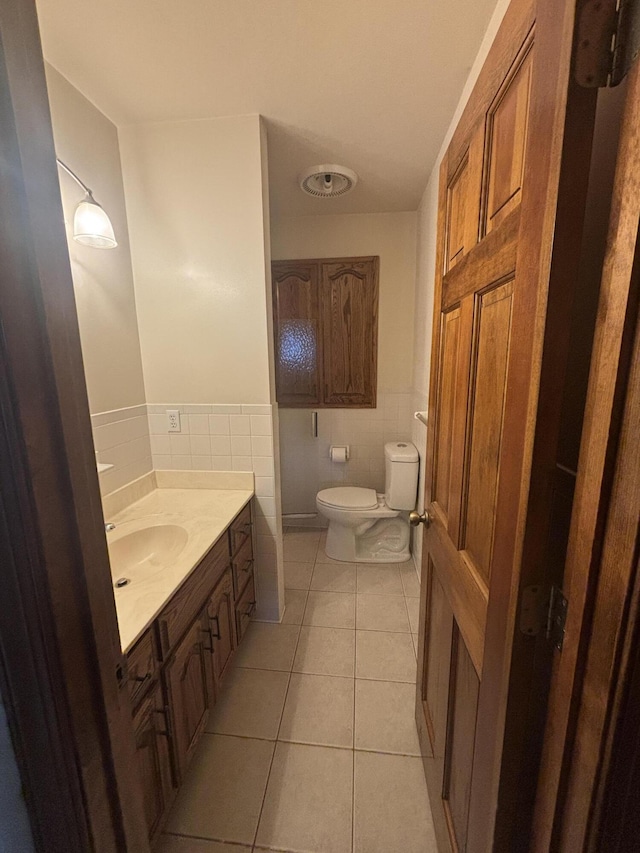 120 Nyle Ridge Rd, Wirtz, VA 24184 - bathroom with tile walls, tile patterned floors, vanity, and a wainscoted wall