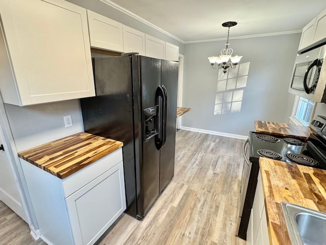 816 Brandon Ave SW, Roanoke, VA 24015 - kitchen with butcher block counters, appliances with stainless steel finishes, a chandelier, light wood-style flooring, and crown molding
