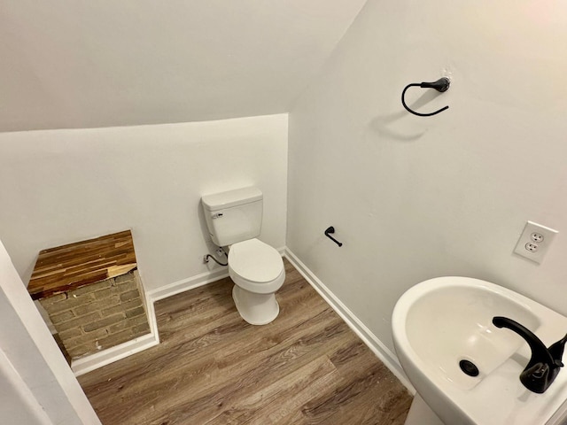 816 Brandon Ave SW, Roanoke, VA 24015 - bathroom featuring wood finished floors, a sink, toilet, and lofted ceiling