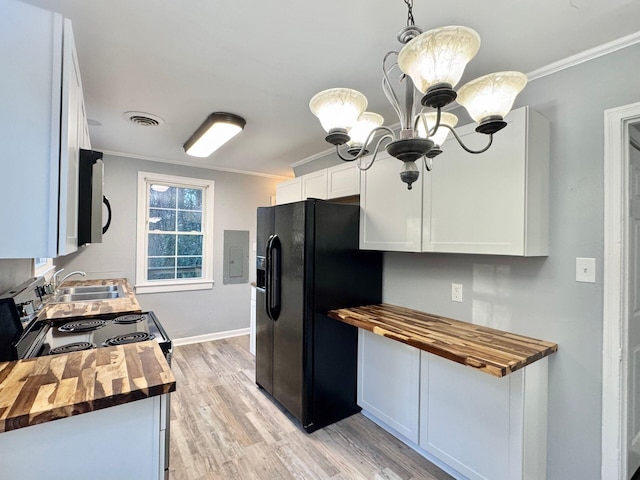 816 Brandon Ave SW, Roanoke, VA 24015 - kitchen with wooden counters, black fridge, ornamental molding, a sink, and light wood finished floors