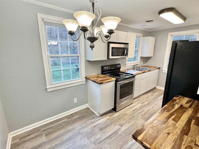 816 Brandon Ave SW, Roanoke, VA 24015 - kitchen featuring appliances with stainless steel finishes, a chandelier, ornamental molding, a sink, and white cabinets
