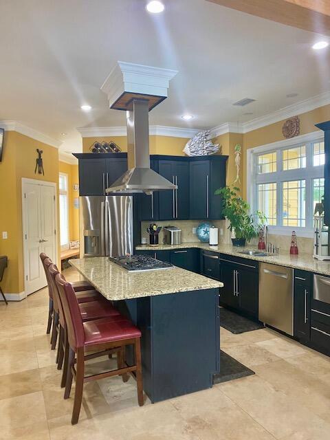 1038 Lees Mill Ln, Goode, VA 24556 - kitchen with appliances with stainless steel finishes, a center island, light stone countertops, a kitchen bar, and a sink
