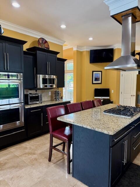 1038 Lees Mill Ln, Goode, VA 24556 - kitchen with stainless steel appliances, island range hood, a kitchen breakfast bar, ornamental molding, and dark cabinets