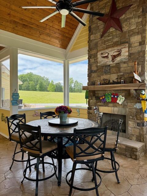 1038 Lees Mill Ln, Goode, VA 24556 - dining area featuring ceiling fan, plenty of natural light, wooden ceiling, high vaulted ceiling, and an outdoor stone fireplace