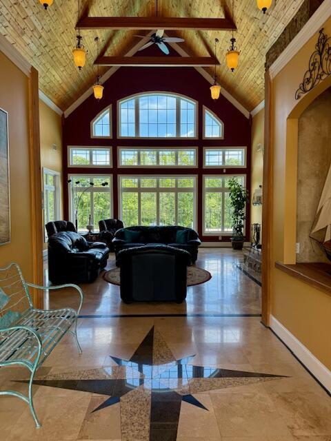 1038 Lees Mill Ln, Goode, VA 24556 - living area featuring healthy amount of natural light, high vaulted ceiling, wooden ceiling, baseboards, and ceiling fan
