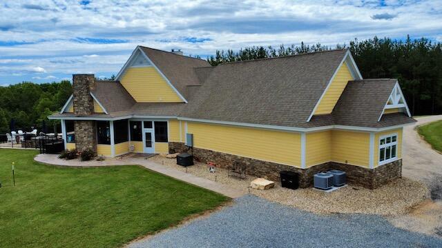 1038 Lees Mill Ln, Goode, VA 24556 - rear view of property with stone siding, a yard, and driveway